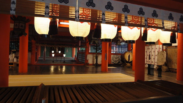 an area of the shine interior lit by a row of large hanging paper lanterns